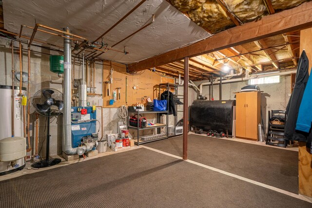basement featuring heating fuel, water heater, and a heating unit