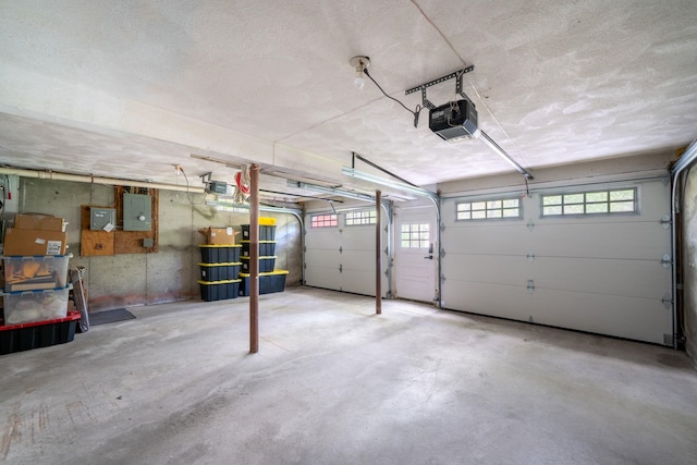 garage featuring a garage door opener and electric panel