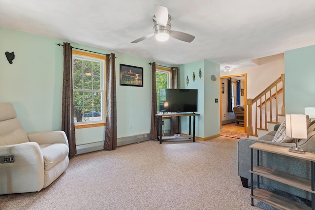 carpeted living room featuring a ceiling fan, stairway, and baseboards