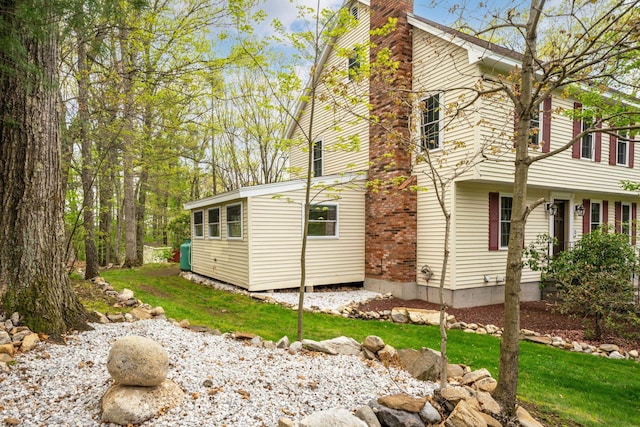 view of property exterior featuring a chimney