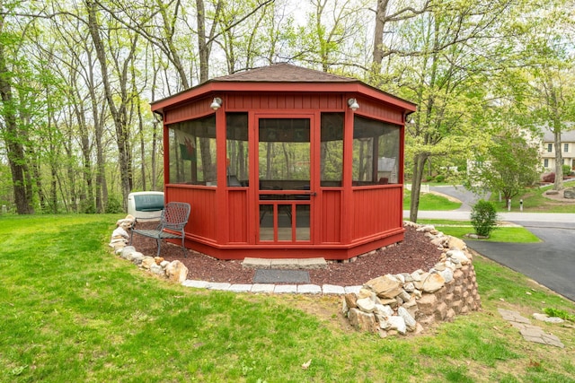 view of outbuilding with a sunroom