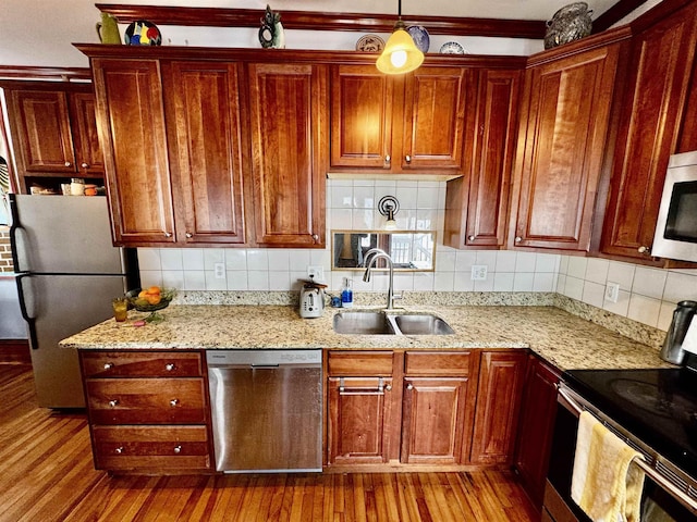 98 Pennacook St, Manchester, NH 03102 - kitchen featuring stainless steel appliances, a sink, wood finished floors, and decorative backsplash