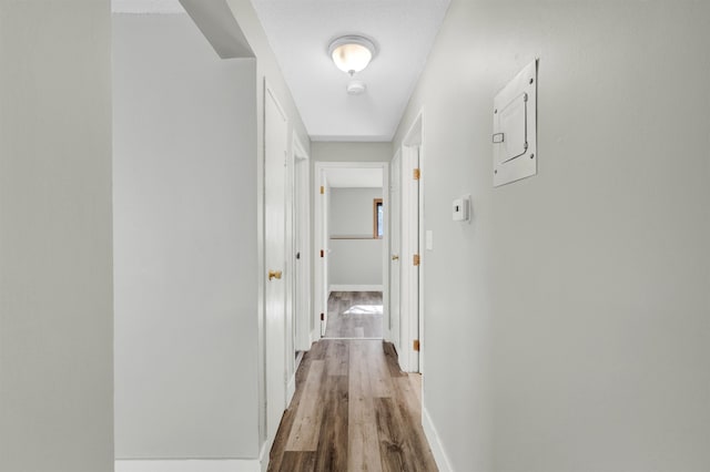 hall with wood finished floors and baseboards