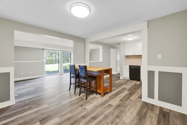 dining space with light wood-style floors and baseboards