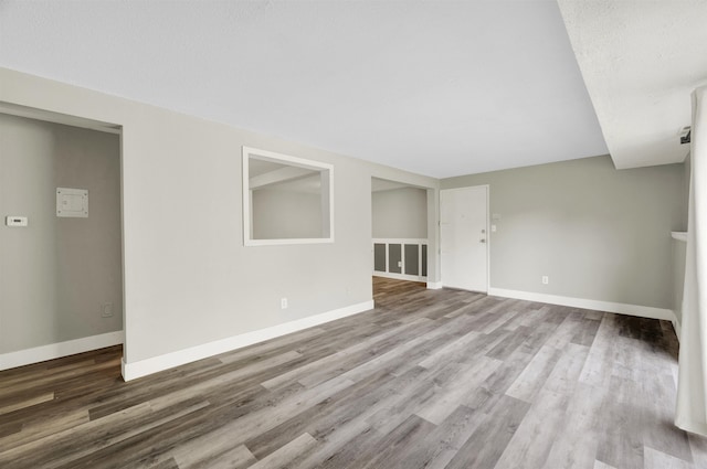 empty room with wood finished floors and baseboards
