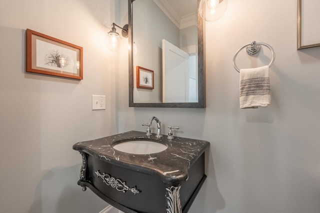 bathroom with ornamental molding and vanity