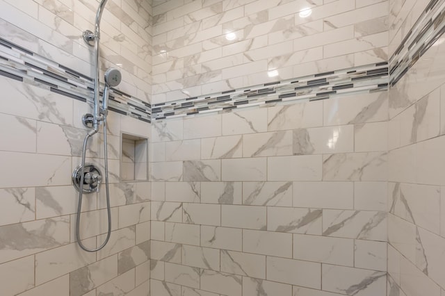 bathroom with a tile shower