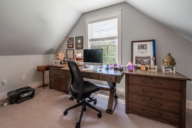 carpeted office featuring lofted ceiling and baseboards
