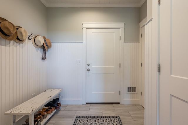 mudroom featuring a wainscoted wall and crown molding