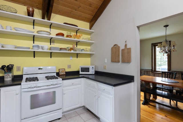 67 Birch Tree Ln, Fayston, VT 05673 - kitchen featuring white appliances, dark countertops, wooden ceiling, a chandelier, and white cabinetry