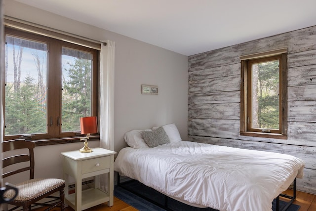 67 Birch Tree Ln, Fayston, VT 05673 - bedroom featuring an accent wall and wood finished floors