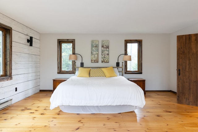 67 Birch Tree Ln, Fayston, VT 05673 - bedroom featuring light wood-type flooring, baseboard heating, and wood walls