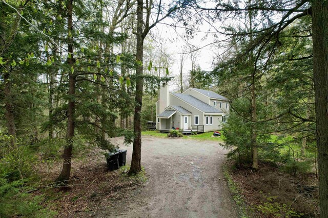 67 Birch Tree Ln, Fayston, VT 05673 - view of property exterior with dirt driveway and a chimney