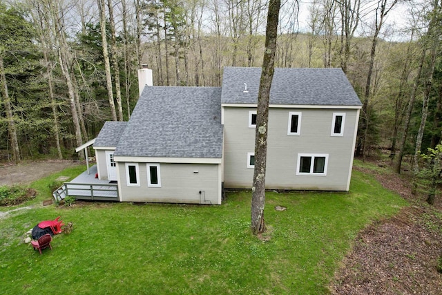 67 Birch Tree Ln, Fayston, VT 05673 - back of house featuring roof with shingles, a chimney, a wooden deck, and a lawn