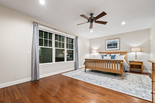 bedroom with baseboards, recessed lighting, and wood finished floors