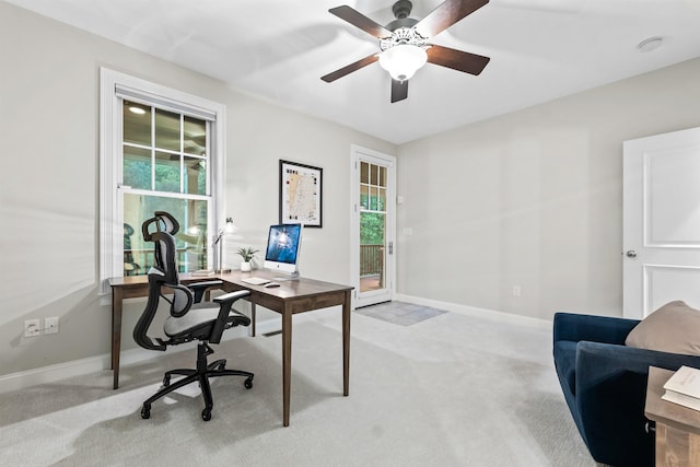 office area featuring light colored carpet, ceiling fan, and baseboards