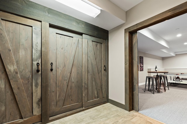 entrance foyer featuring baseboards and wood finished floors