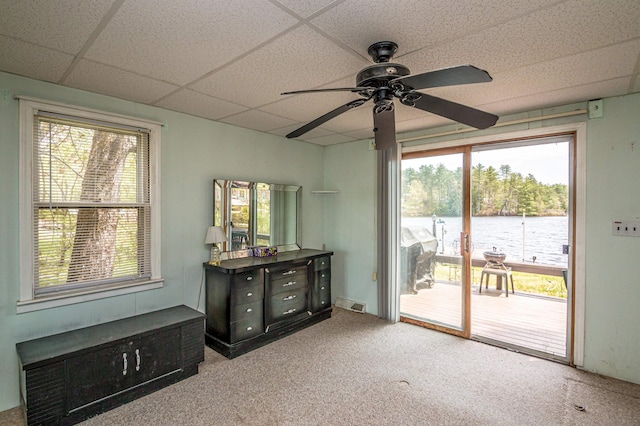 59 Lake Rd, Wakefield, NH 03872 - carpeted empty room with a water view, a ceiling fan, and a paneled ceiling