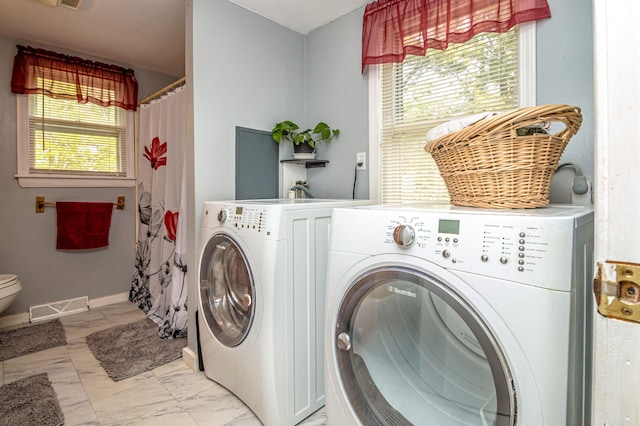 59 Lake Rd, Wakefield, NH 03872 - laundry room with washer and dryer, healthy amount of natural light, and light marble finish floors