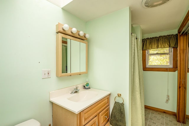 59 Lake Rd, Wakefield, NH 03872 - bathroom with vanity, toilet, and baseboards