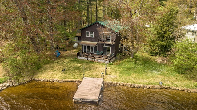59 Lake Rd, Wakefield, NH 03872 - view of property exterior featuring a lawn, a dock, a deck with water view, and a view of trees
