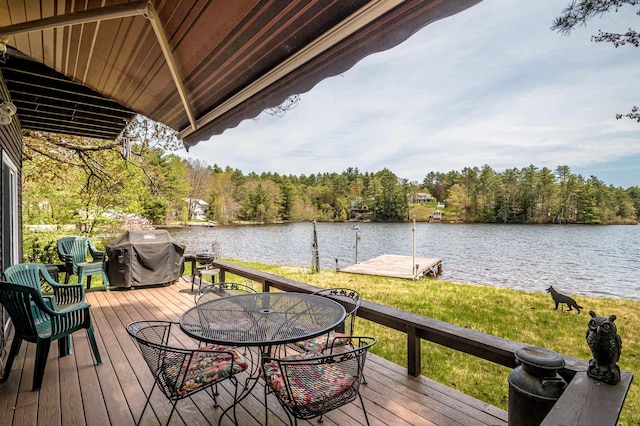 59 Lake Rd, Wakefield, NH 03872 - deck featuring area for grilling, a water view, outdoor dining area, a wooded view, and a lawn