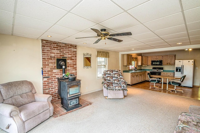 59 Lake Rd, Wakefield, NH 03872 - living room featuring a wood stove, a drop ceiling, carpet, and ceiling fan