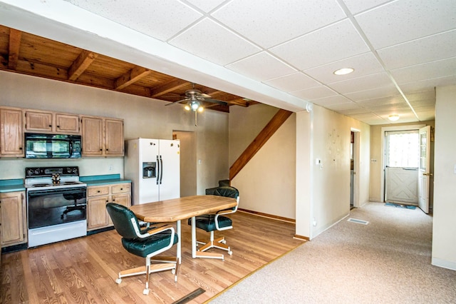 59 Lake Rd, Wakefield, NH 03872 - kitchen featuring black microwave, range with electric stovetop, white fridge with ice dispenser, baseboards, and light brown cabinetry