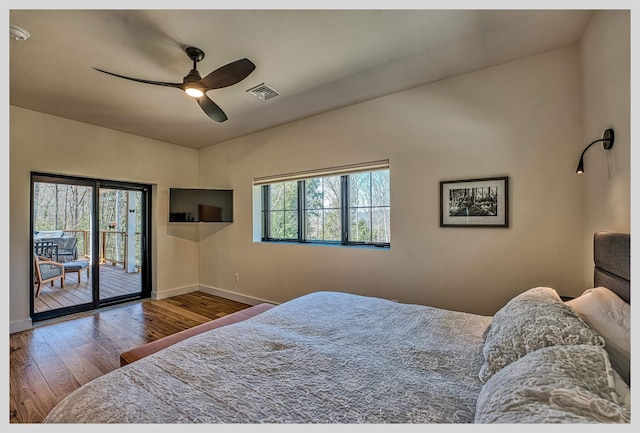 bedroom featuring access to outside, baseboards, wood finished floors, and ceiling fan