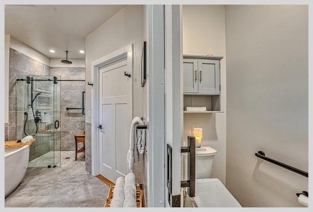 bathroom with a shower stall, a freestanding tub, recessed lighting, and toilet