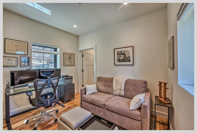 office with light wood-style floors, recessed lighting, and baseboards