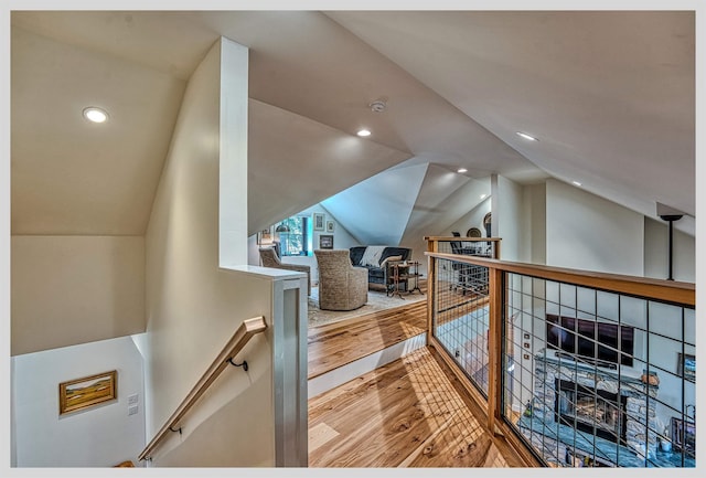 additional living space featuring wood finished floors, vaulted ceiling, and recessed lighting