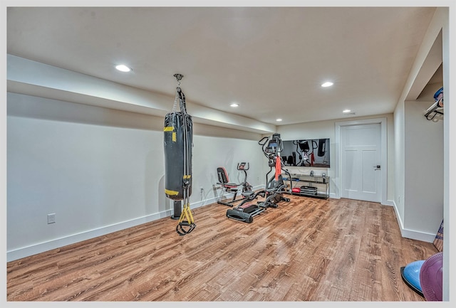 workout room featuring wood finished floors, baseboards, and recessed lighting
