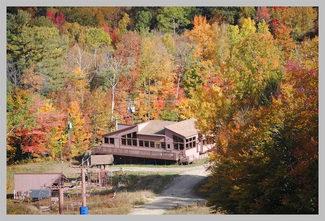 view from above of property with a heavily wooded area