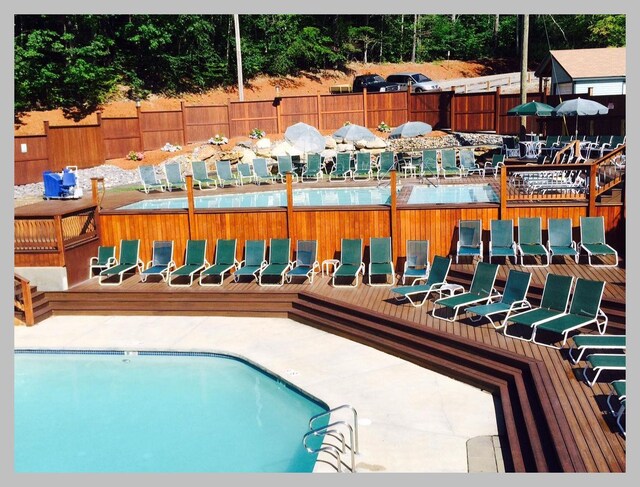 view of swimming pool with a deck