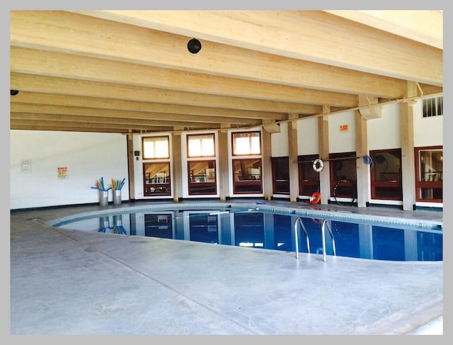 indoor pool featuring a patio area