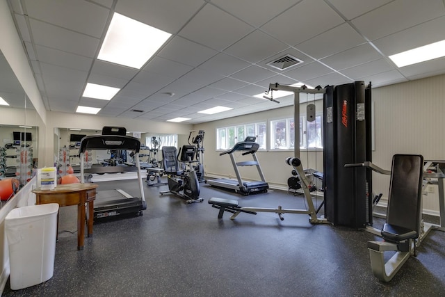 exercise room with a paneled ceiling