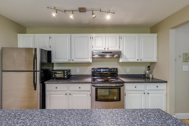 kitchen with stainless steel appliances, under cabinet range hood, white cabinets, and dark stone countertops