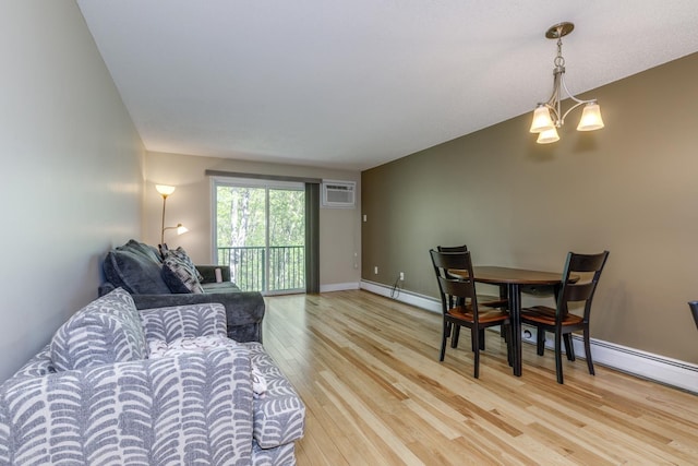 living room featuring light wood-type flooring, an AC wall unit, baseboard heating, and baseboards