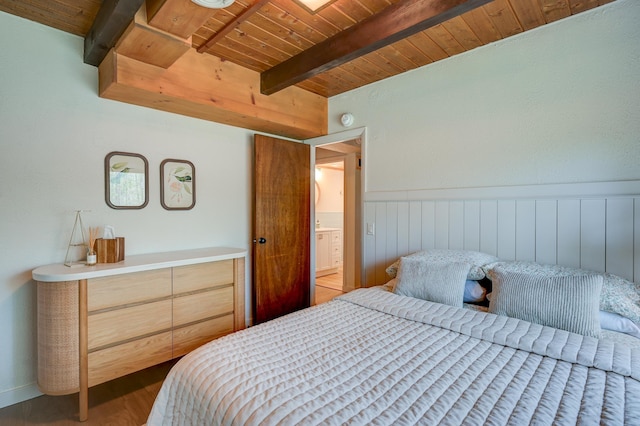 bedroom with wooden ceiling, beam ceiling, wood finished floors, and wainscoting