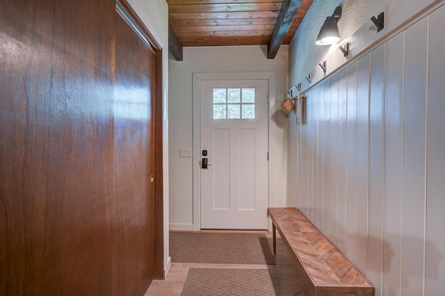 mudroom featuring beamed ceiling, wood ceiling, and light wood finished floors