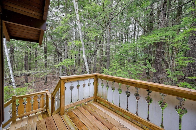 wooden deck featuring a forest view