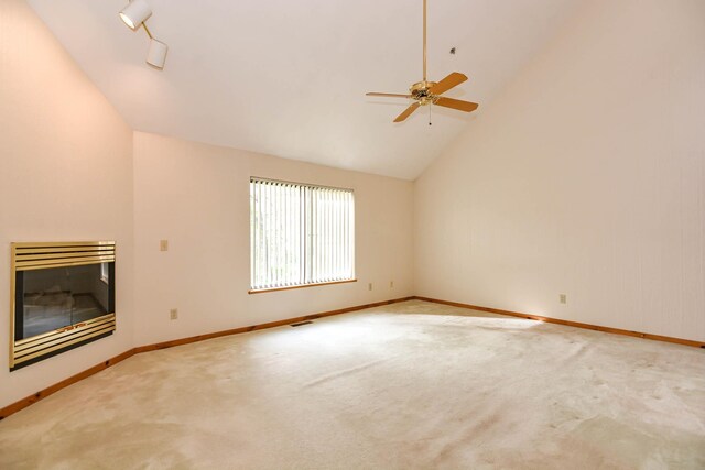 52 Ridgewood Dr Unit 14C, Atkinson, NH 03811 - unfurnished living room featuring a glass covered fireplace, lofted ceiling, carpet flooring, ceiling fan, and baseboards