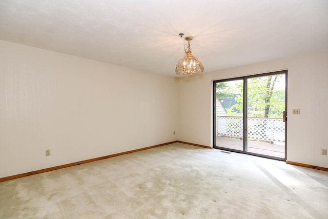 52 Ridgewood Dr Unit 14C, Atkinson, NH 03811 - empty room featuring baseboards, a chandelier, and light colored carpet