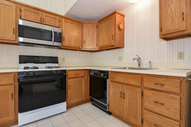 52 Ridgewood Dr Unit 14C, Atkinson, NH 03811 - kitchen featuring gas range oven, stainless steel microwave, dishwasher, a sink, and light tile patterned flooring