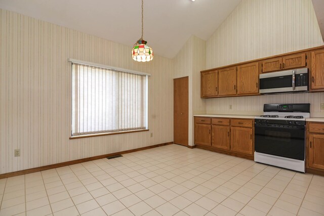52 Ridgewood Dr Unit 14C, Atkinson, NH 03811 - kitchen featuring stainless steel microwave, gas stove, wallpapered walls, brown cabinets, and light countertops
