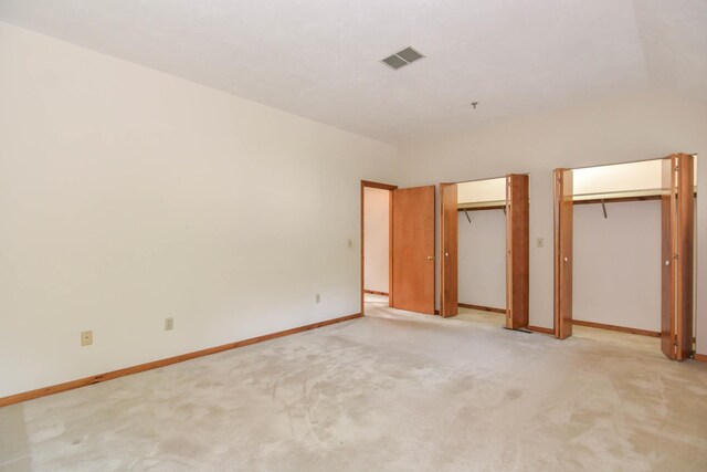 52 Ridgewood Dr Unit 14C, Atkinson, NH 03811 - unfurnished bedroom with two closets, light colored carpet, and baseboards