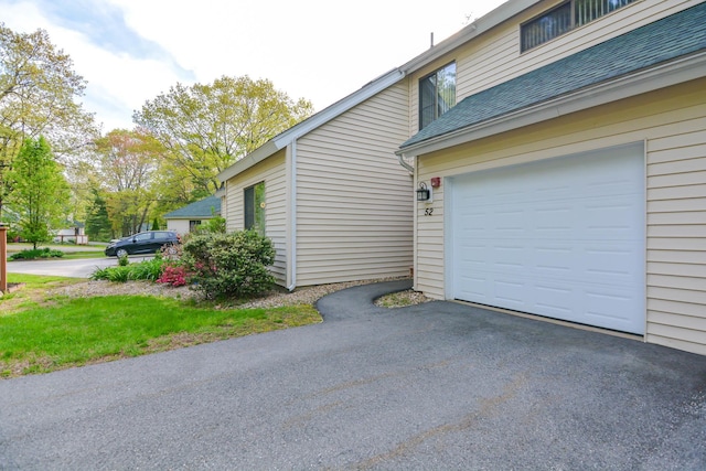 52 Ridgewood Dr Unit 14C, Atkinson, NH 03811 - view of side of home featuring a shingled roof and asphalt driveway
