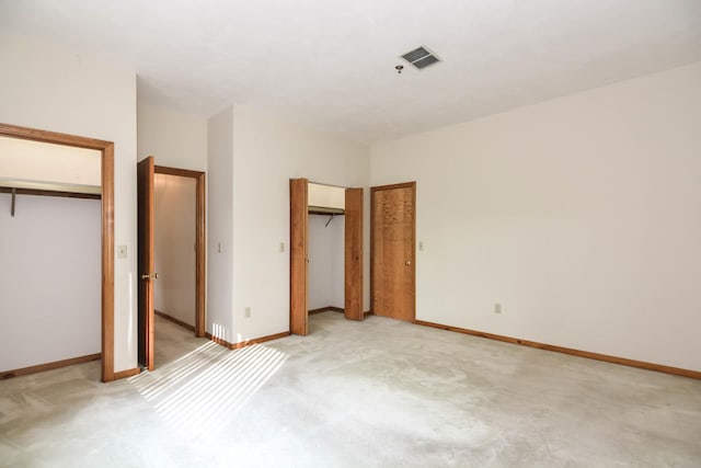 52 Ridgewood Dr Unit 14C, Atkinson, NH 03811 - unfurnished bedroom with multiple closets, light carpet, and baseboards