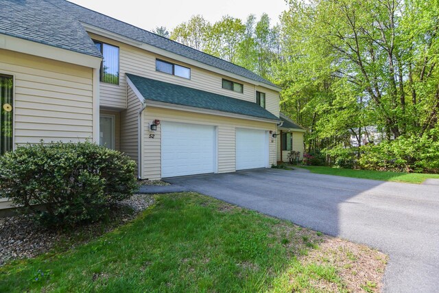 52 Ridgewood Dr Unit 14C, Atkinson, NH 03811 - view of home's exterior featuring an attached garage, asphalt driveway, and a shingled roof